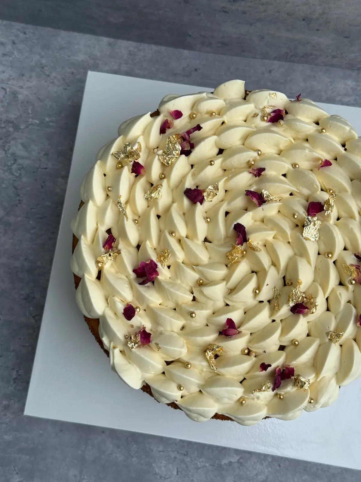 Square chocolate and vanilla layered cake finished with a smooth chocolate glaze and gold leaf.